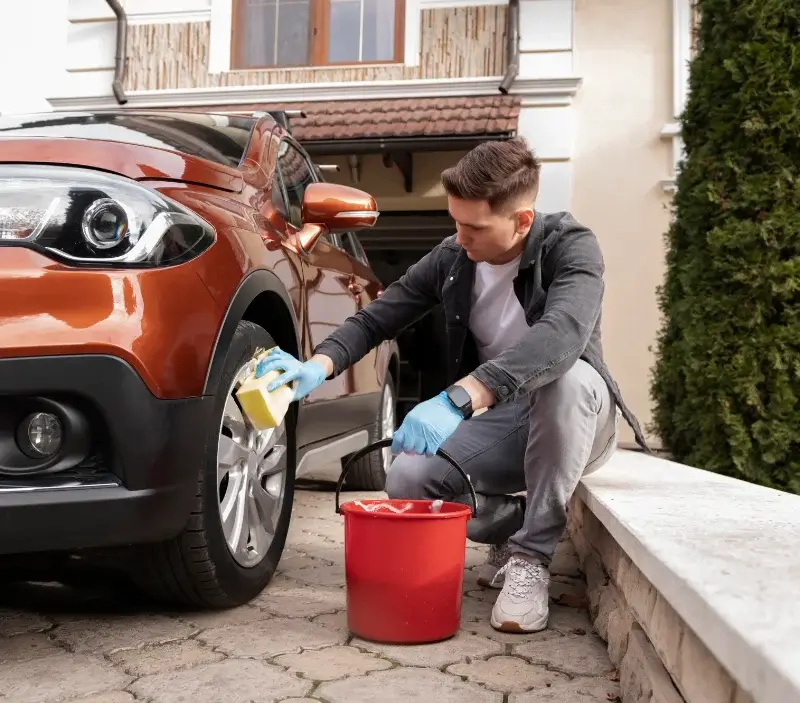 Lavage auto à domicile Argentat-sur-Dordogne : professionnel intervenant sur un véhicule